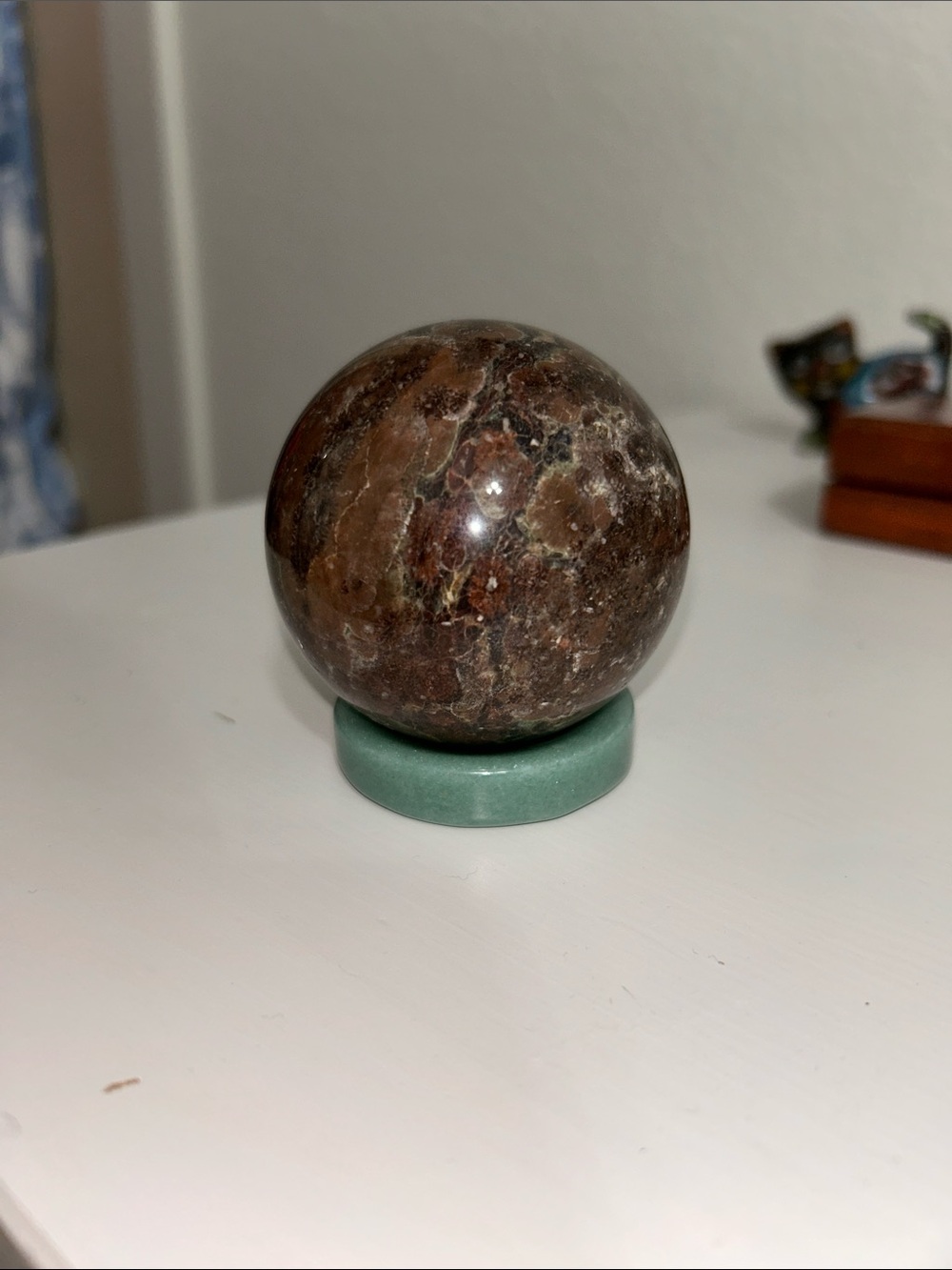 Polished Brown Marble Sphere on Green Stand